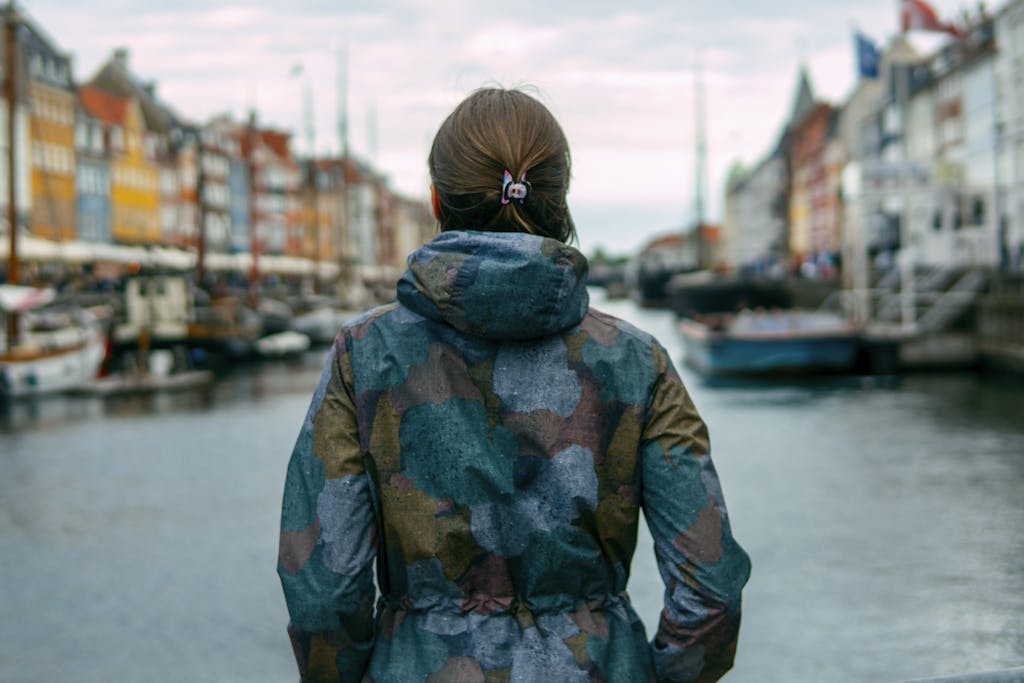 A woman enjoying the scenic view of Nyhavn canal in Copenhagen, Denmark.