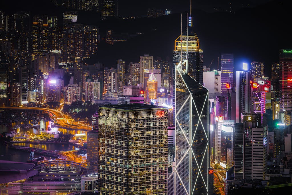 Spectacular view of Hong Kong skyscrapers illuminated at night showcasing modern architecture and urban life.