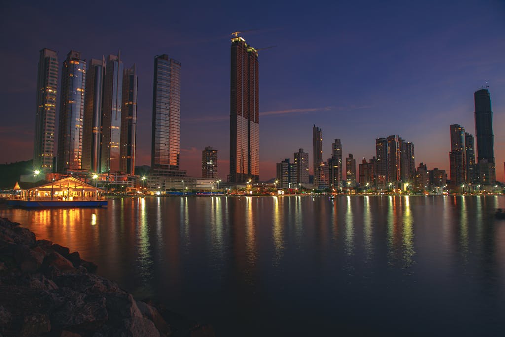 Stunning dusk cityscape of Balneário Camboriú, Brazil with reflections on the waterfront.