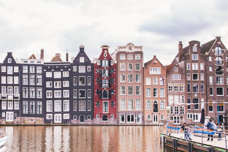 Historic Amsterdam canal houses reflecting in the water showcasing architectural beauty.