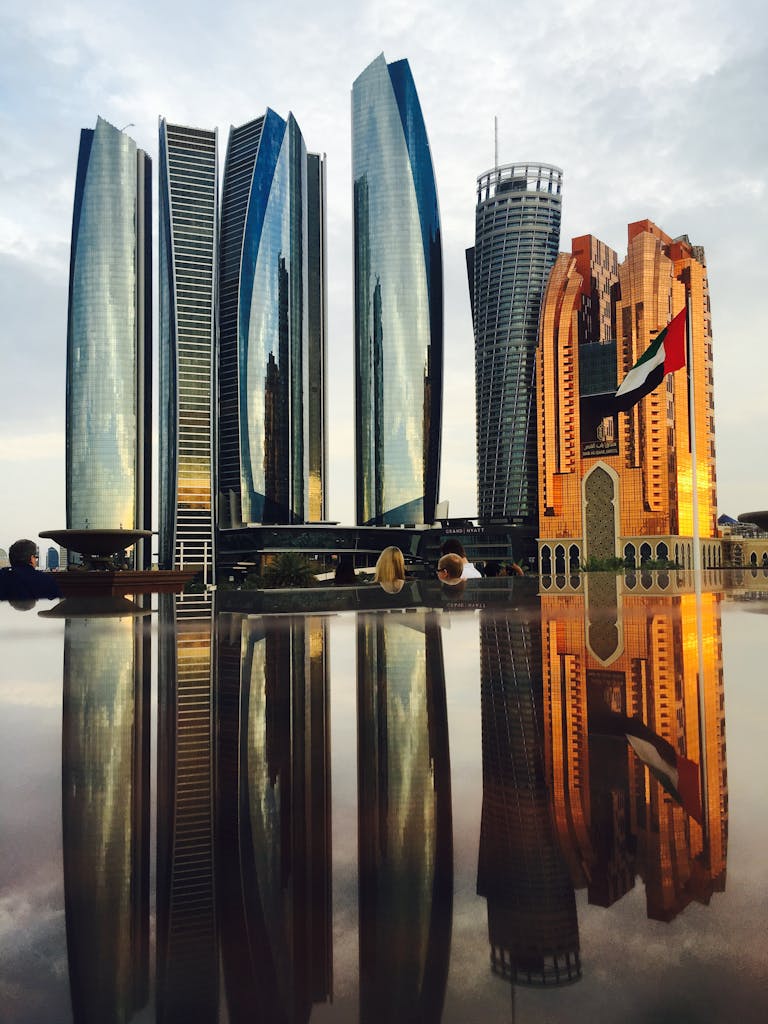 Stunning view of Abu Dhabi's skyline with modern skyscrapers reflecting beautifully at twilight.