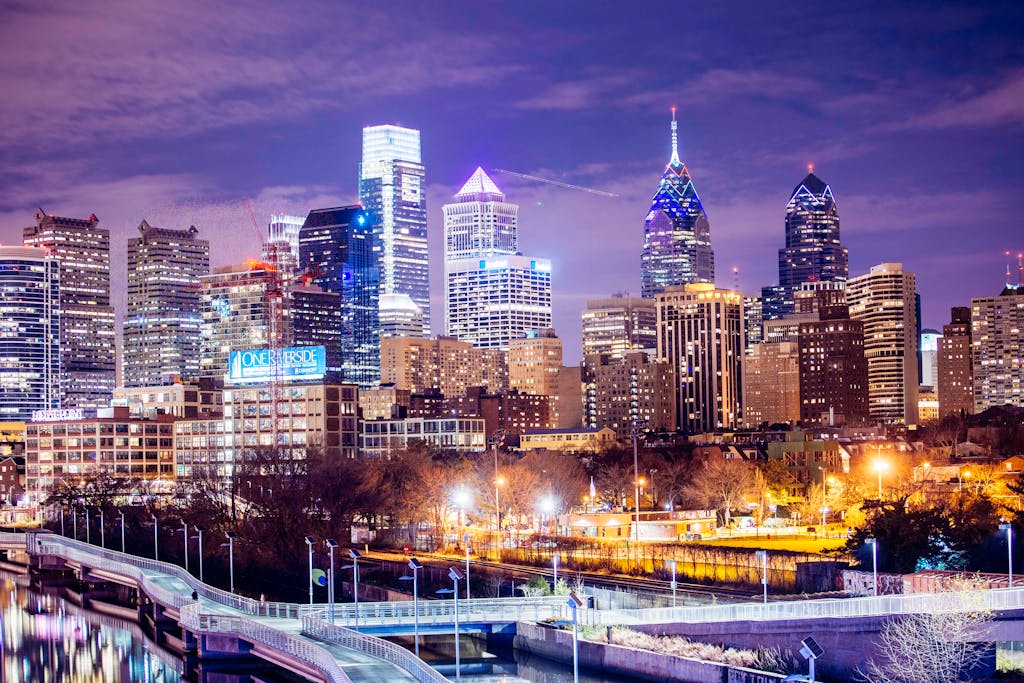 A vibrant view of Philadelphia's illuminated skyline at night showcasing modern skyscrapers.